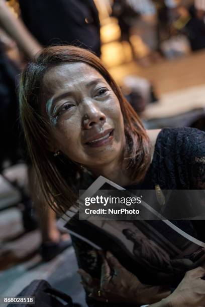 Mourners cry at the final procession to enshrine the relics of the late Thai King Bhumiphol Adulyadej in Bangkok on October 29 2017