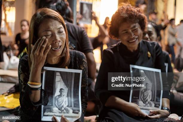 Mourners cry at the final procession to enshrine the relics of the late Thai King Bhumiphol Adulyadej in Bangkok on October 29 2017