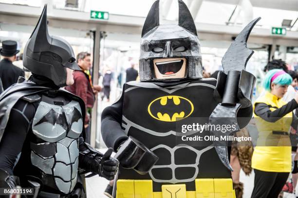 Batman cosplayer and a lego batman cosplayer in conversation during Day 3 of the MCM London Comic Con 2017 held at the ExCel on October 29, 2017 in...