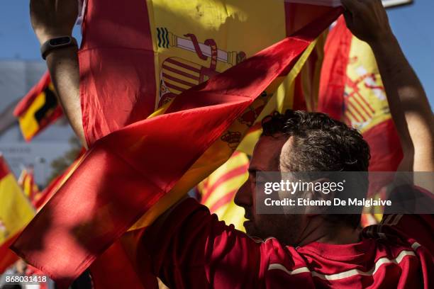 Spanish government supporters wave Spanish flags and carry banners during a large pro-unity demonstration on October 29, 2017 in Barcelona, Spain....