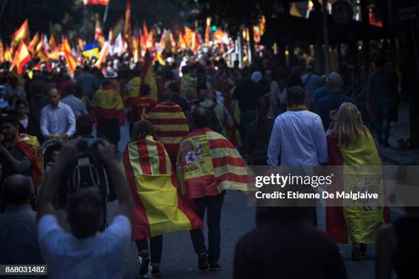 Spanish government supporters wave Spanish flags and carry banners during a large pro-unity demonstration on October 29, 2017 in Barcelona, Spain....