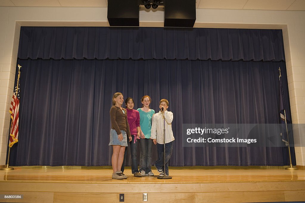 Group of children singing on stage