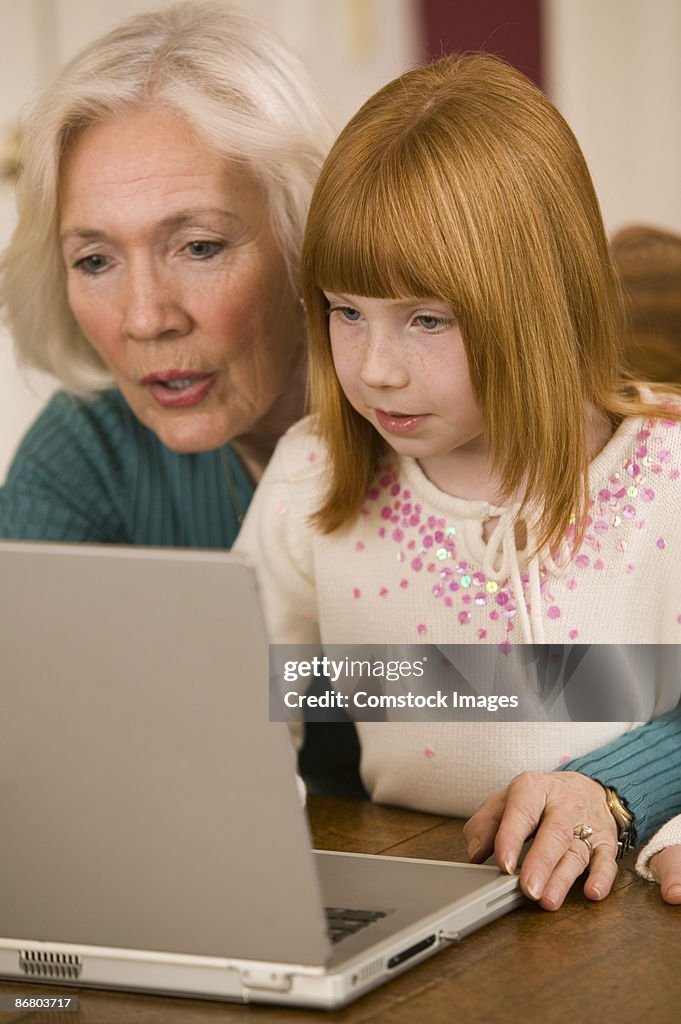 Grandmother and granddaughter with laptop