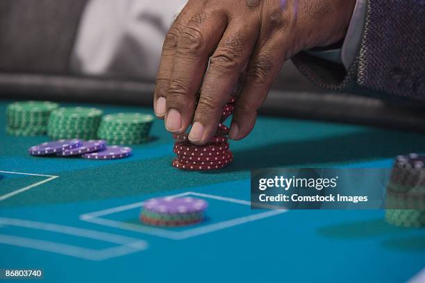 man's fingers stacking poker chips - casino tables hands stock pictures, royalty-free photos & images