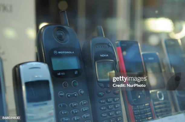 Classic mobile phones are seen in a shop window display in Bydgoszcz, Poland on October 29, 2017.