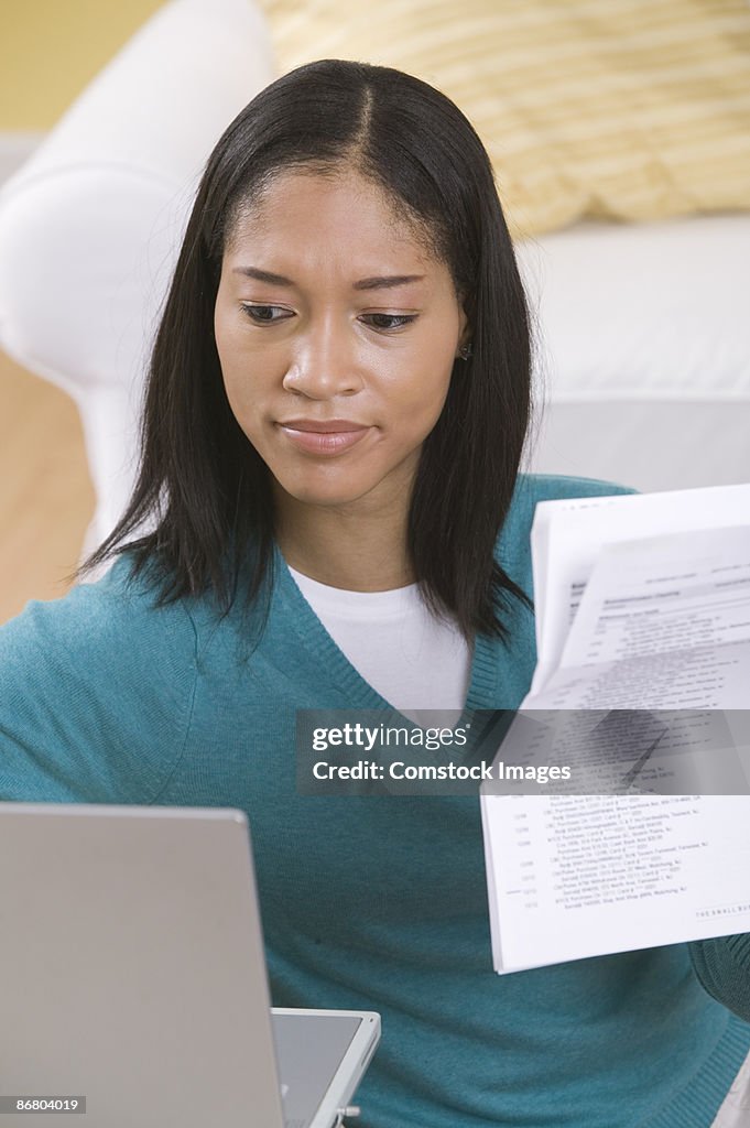 Woman with bills and laptop