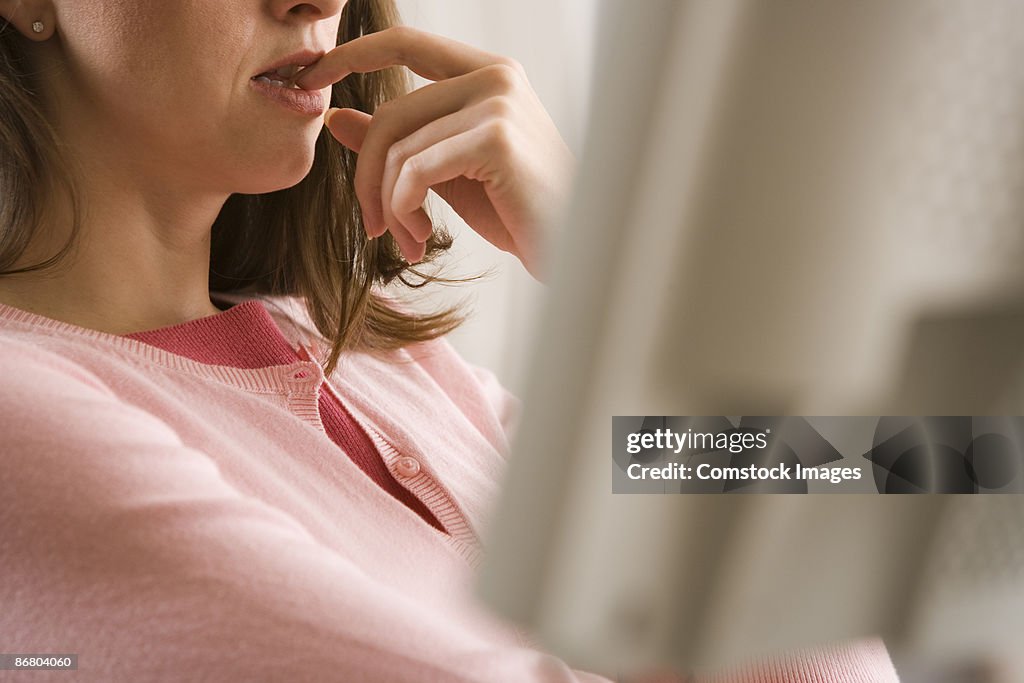 Woman biting her nail