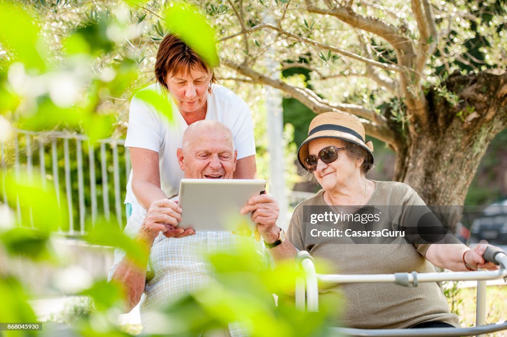 管理人の高齢者を示すデジタル タブレットを使用する方法