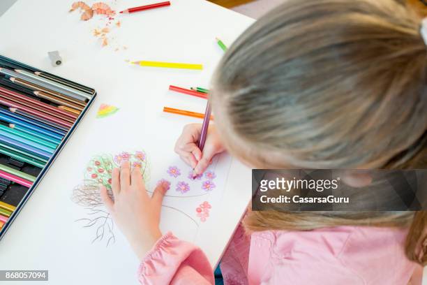 high angle view of young girl drawing tree on white paper - colored pencils stock pictures, royalty-free photos & images