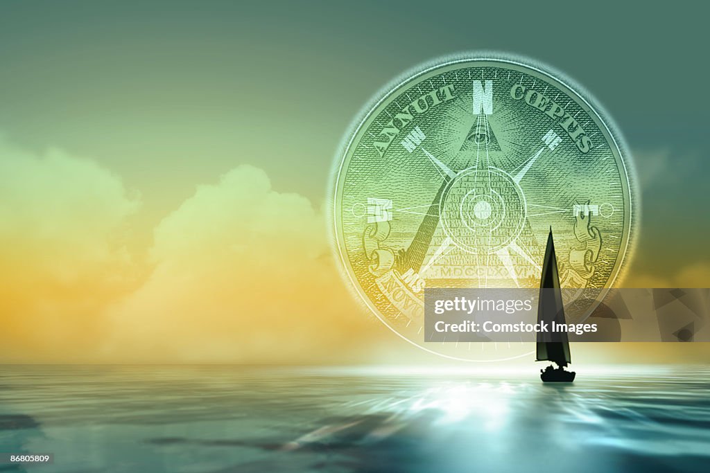 Sailboat on water with compass