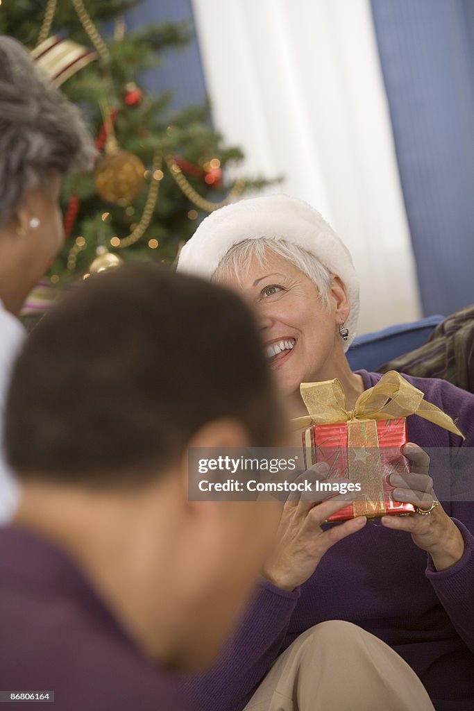 Group of people exchanging gifts at a christmas party