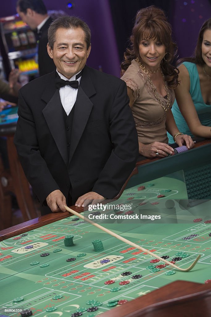 Dealer at craps table and woman