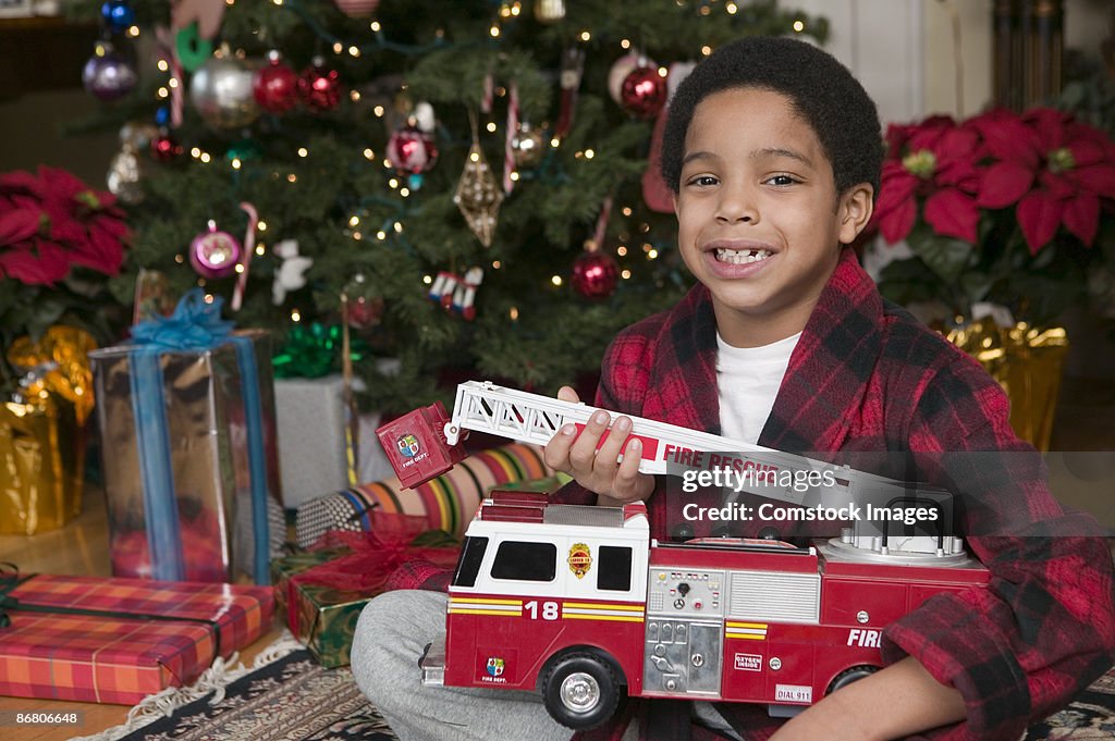 Boy with toy firetruck