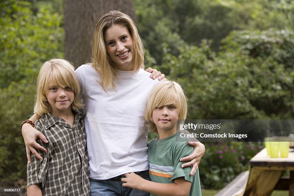 Mother embracing two sons