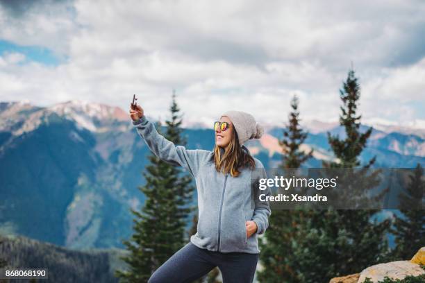 pregnant woman taking photos with smartphone in the mountains - co op stock pictures, royalty-free photos & images