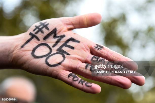 Picture shows the messages "#Me too" and #Balancetonporc on the hand of a protester during a gathering against gender-based and sexual violence...