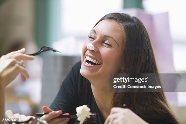 two people being silly with food - human nose stockfoto's en -beelden
