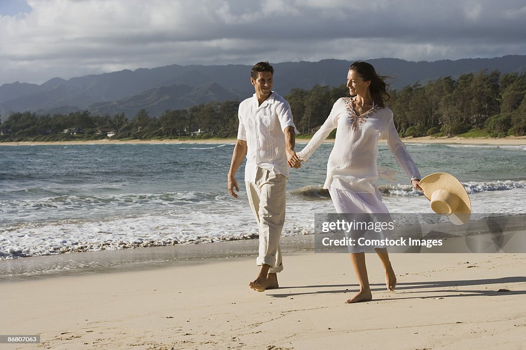 Couple walking along beach together