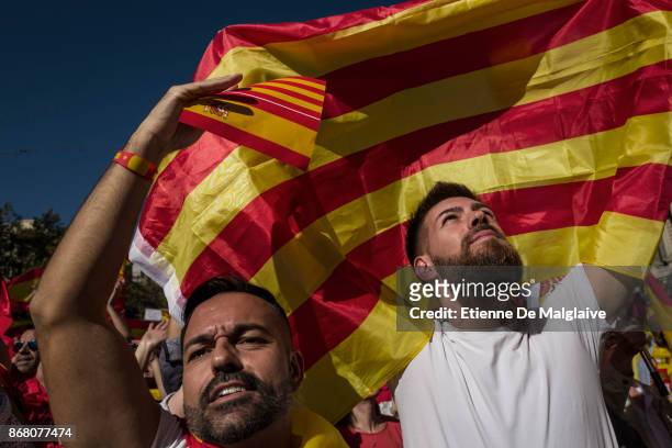 Spanish government supporters wave Spanish flags and carry banners during a large pro-unity demonstration on October 29, 2017 in Barcelona, Spain....