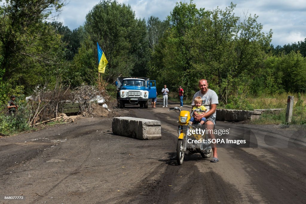 A father with his son seen riding on a motorbike at a...