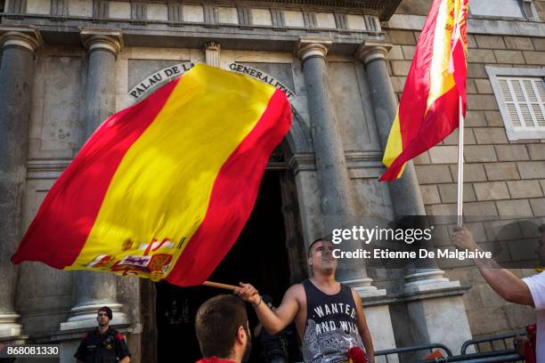 Spanish government supporters wave Spanish flags and carry banners during a large pro-unity demonstration on October 29, 2017 in Barcelona, Spain. A...