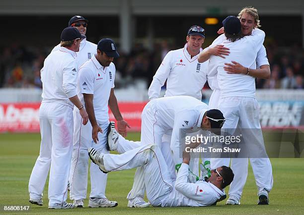 Stuart Broad of England celebrates the wicket of Fidel Edwards of West Indies as Tim Bresnan celebrates his catch during day three of the 1st npower...