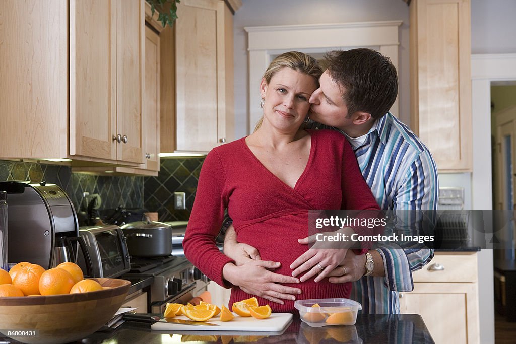 Man hugging pregnant woman