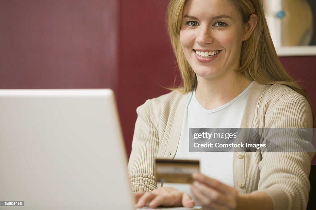 Woman with a credit card and laptop