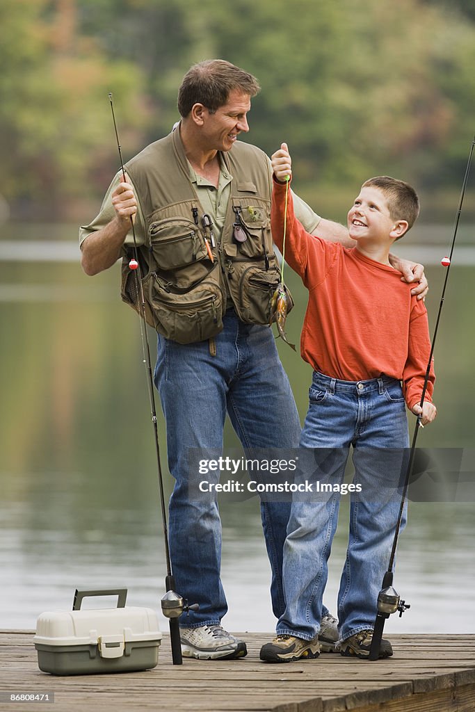 Father and son holding up a fish