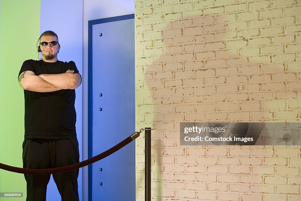 Bouncer standing outside nightclub