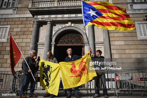 Man holds a independence flag outside the Palau Catalan Regional Government Building as Catalonia returns to work following last week's decision by...