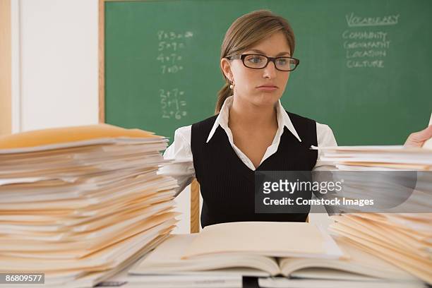 teacher with papers - overworked teacher stock pictures, royalty-free photos & images