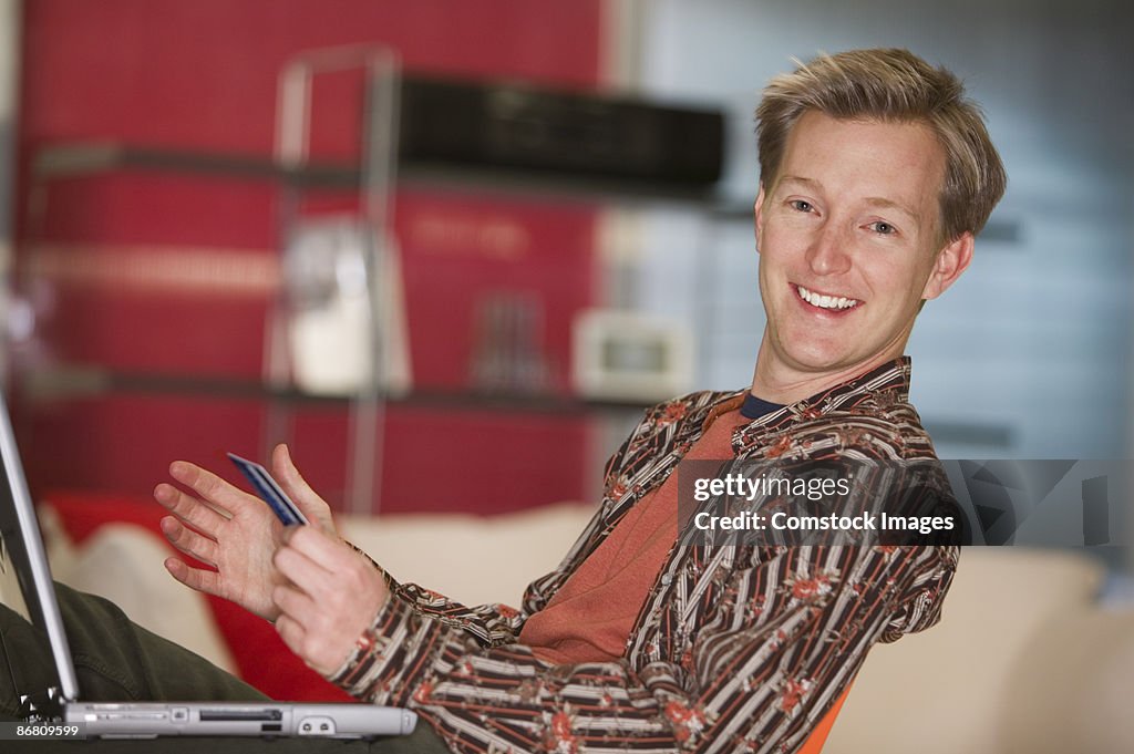 Man on computer with his credit card