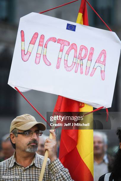 Pro-unionist backer holds a Spanish flag outside the Palau Catalan Regional Government Building as Catalonia returns to work following last week's...