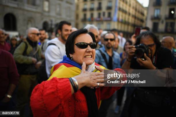 Independence and pro-unionist supporters react outside the Palau Catalan Regional Government Building as Catalonia returns to work following last...