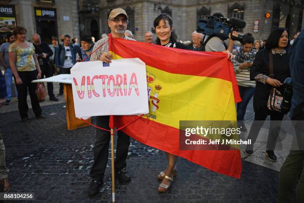 Spanish pro-unionists and independence supporters gather outside the Palau Catalan Regional Government Building as Catalonia returns to work...