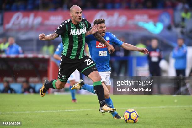 Paolo Cannavaro competes for the ball with Dries Mertens of SSC Napoli during the Serie A TIM match between SSC Napoli and US Sassuolo at Stadio San...
