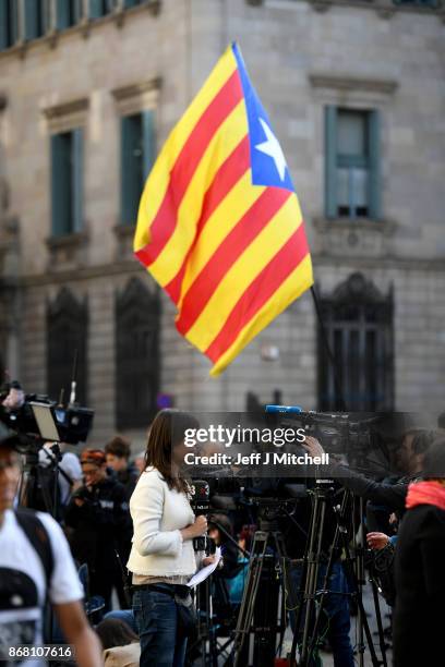 Television crews gather outside the Palau Catalan Regional Government Building as Catalonia returns to work following last week's decision by the...