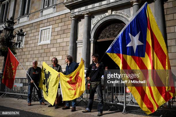 Man holds a independence flag outside the Palau Catalan Regional Government Building as Catalonia returns to work following last week's decision by...