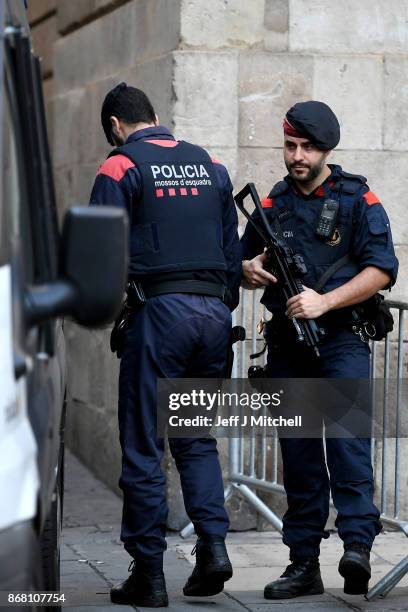 Police stand guard outside the Palau Catalan Regional Government Building, as Catalonia returns to work following last week's decision by the Catalan...