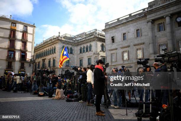 Television crews gather outside the Palau Catalan Regional Government Building as Catalonia returns to work following last week's decision by the...