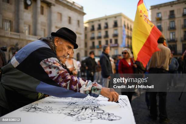 An artist sketches outside the Palau Catalan Regional Government Building as Catalonia returns to work following last week's decision by the Catalan...
