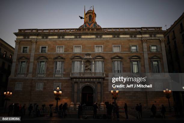 Television crews gather outside the Palau Catalan Regional Government Building as Catalonia returns to work following last week's decision by the...