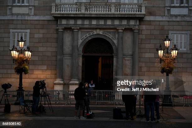 Television crews gather outside the Palau Catalan Regional Government Building as Catalonia returns to work following last week's decision by the...
