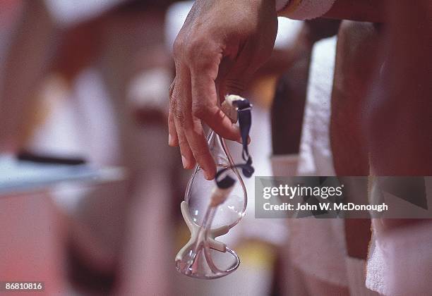 Closeup of hands of Los Angeles Lakers Kareem Abdul-Jabbar holding goggles on sidelines bench before game vs Utah Jazz at Thomas & Mack Center....