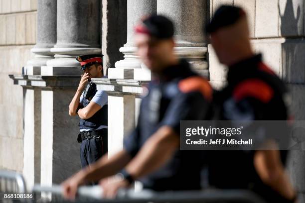 Police stand guard outside the Palau Catalan Regional Government Building, as Catalonia returns to work following last week's decision by the Catalan...