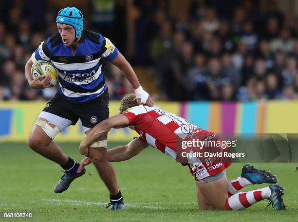 Zach Mercer of Bath is held by Richard Hibbard during the Aviva Premiership match between Bath Rugby and Gloucester Rugby at the Recreation Ground on...