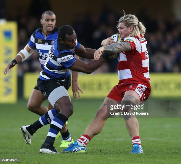 Richard Hibbard of Gloucester is tackled by Semesa Rokodugni during the Aviva Premiership match between Bath Rugby and Gloucester Rugby at the...
