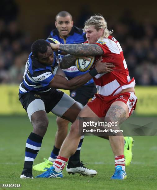 Richard Hibbard of Gloucester is tackled by Semesa Rokodugni during the Aviva Premiership match between Bath Rugby and Gloucester Rugby at the...