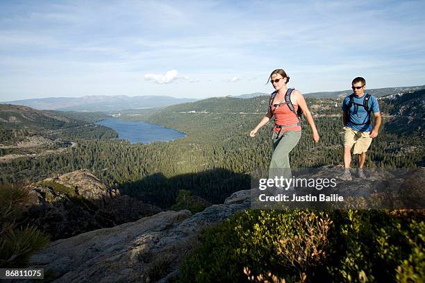 young woman and man hiking near donner pass, ca. - donner pass stock pictures, royalty-free photos & images